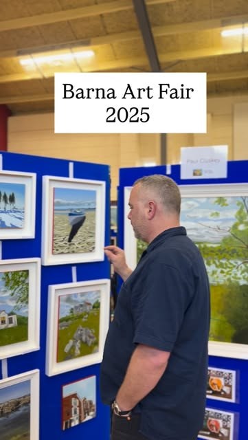 Visitor browsing framed paintings at Barna Art Fair 2025